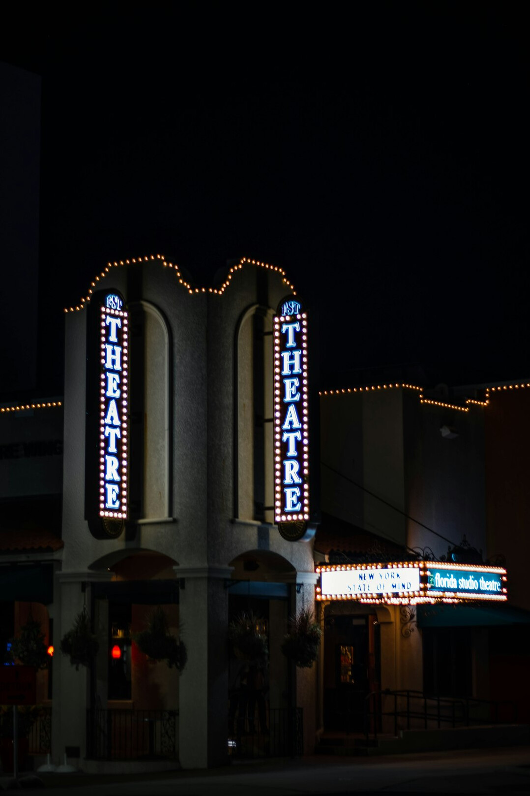 Theater entrance with glowing marquee lights at night