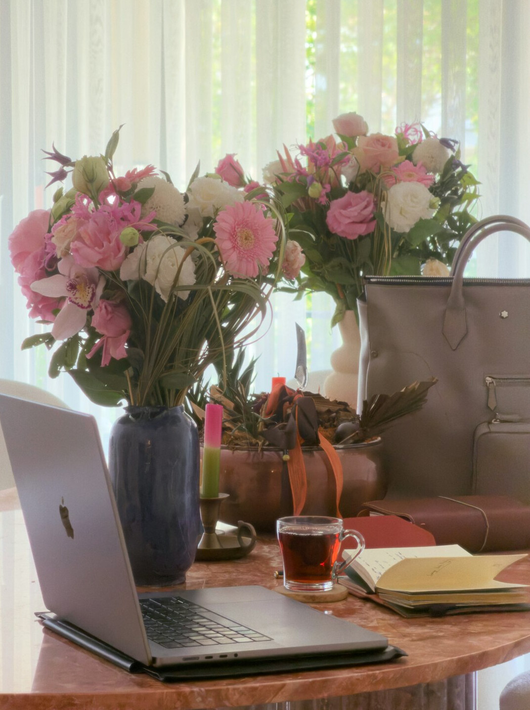 Desk with a laptop, a notebook and a small plant ready for writing a message